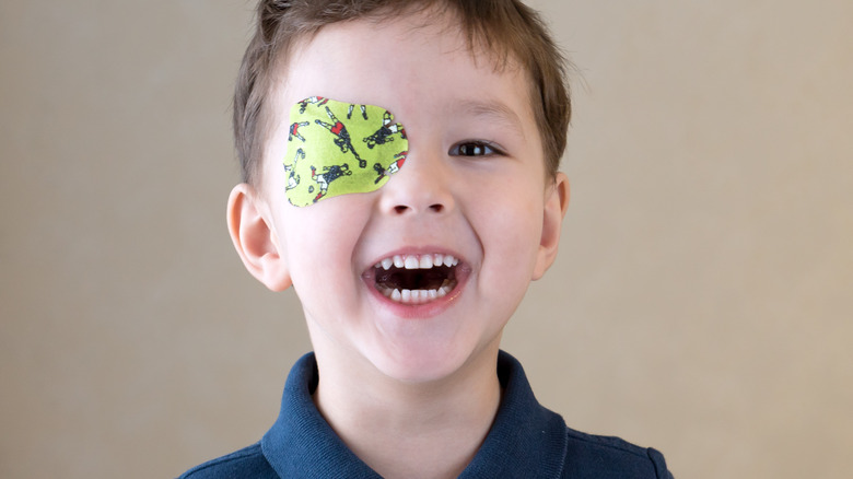 boy wearing soccer-related green eye patch