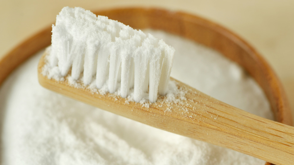 Bowl of baking soda with toothbrush