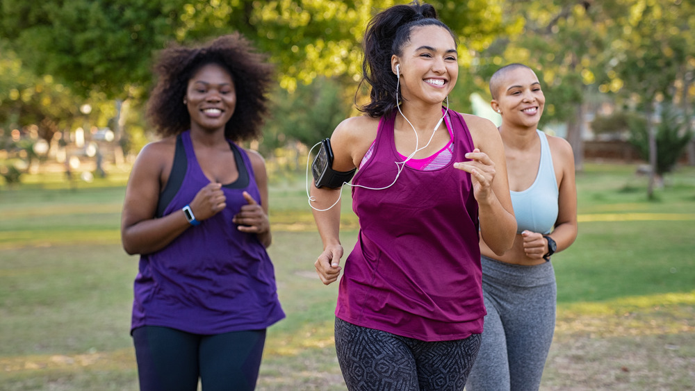 Group of women smiling while running