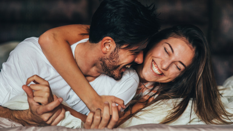 young couple smiling and embracing