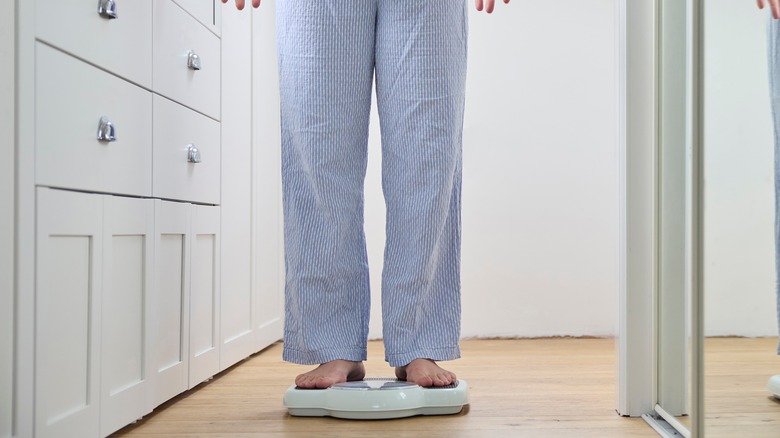 Woman standing on weighing scale