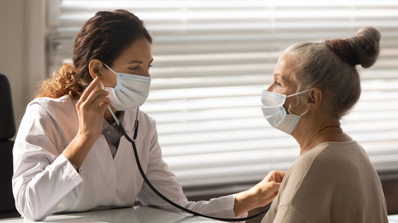 An elderly woman gets her heart checked