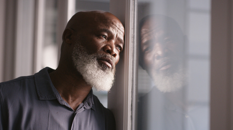 Sad man looking out of window