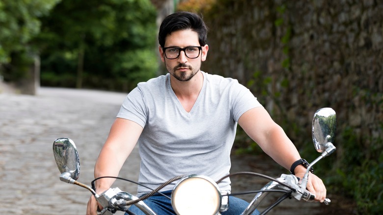 Man riding a motorcycle without a helmet