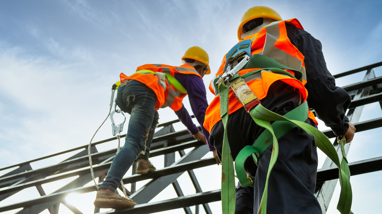 Men working on construction site and climbing