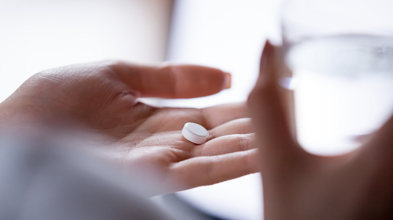 woman taking a pill for headache