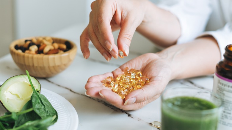 Woman taking vitamins from hand