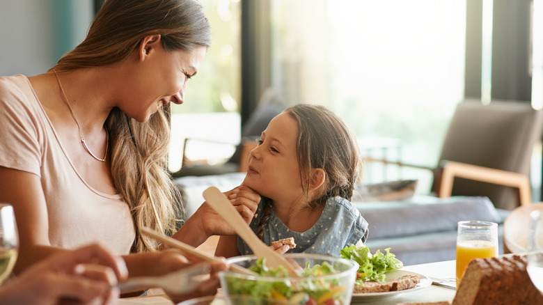 Woman and child preparing salad