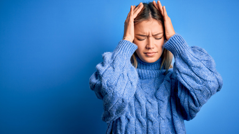 Woman holding head in stress