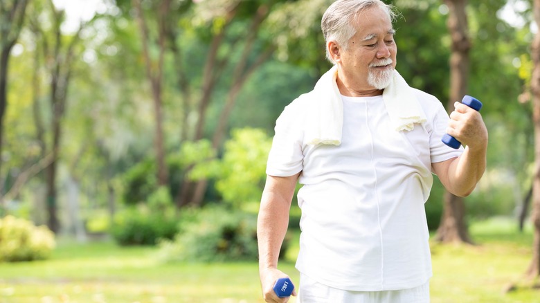 elderly man lifting weight