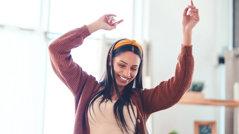 Young woman dancing at home