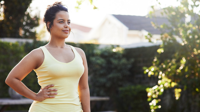 Young woman standing outside during workout