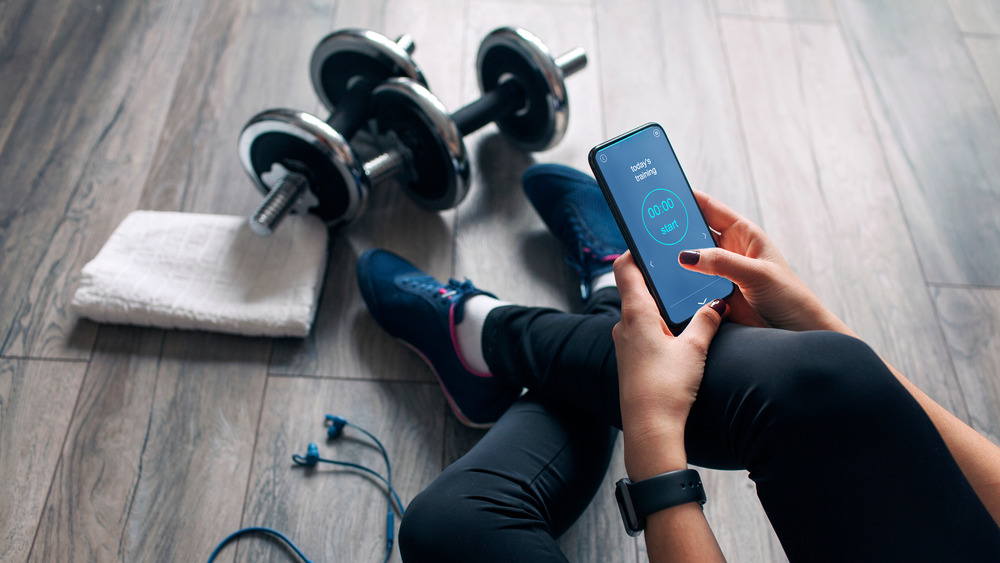 woman tracking exercise phone