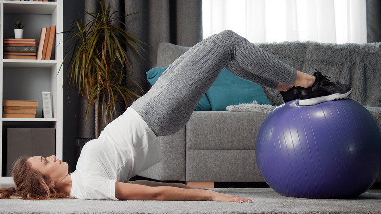 Woman exercising on Swiss ball