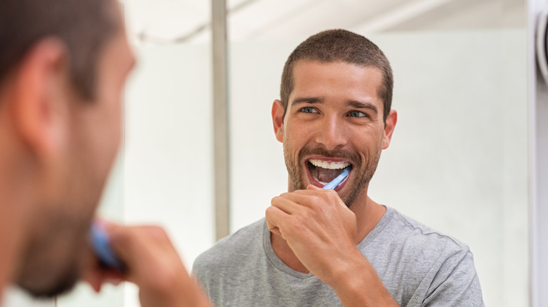 A man brushes his teeth