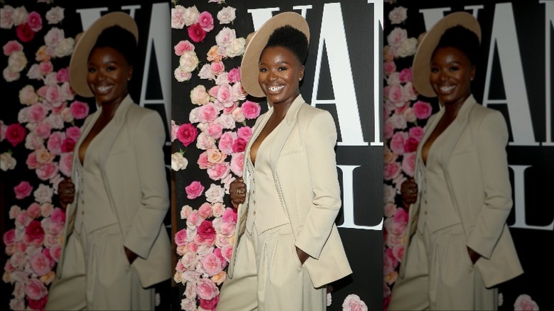 Folake Olowofoyeku smiling, wearing sideways hat