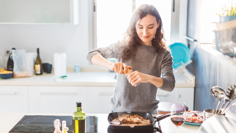 woman grilling meat