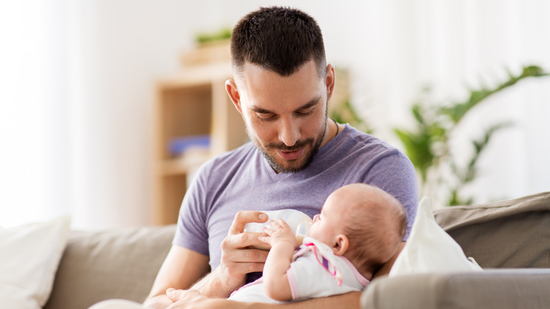 Father bottle feeding his baby