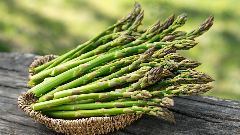 Bunch of asparagus in outdoor basket