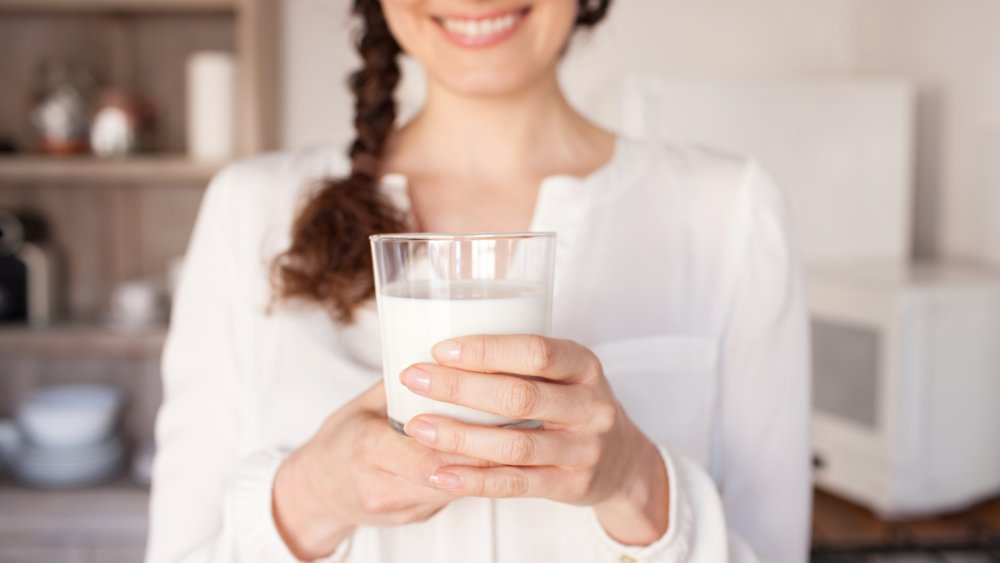woman holding glass of milk