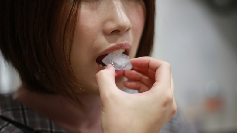 Woman chewing ice