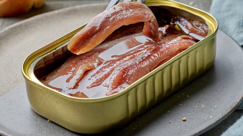 anchovies in can on plate