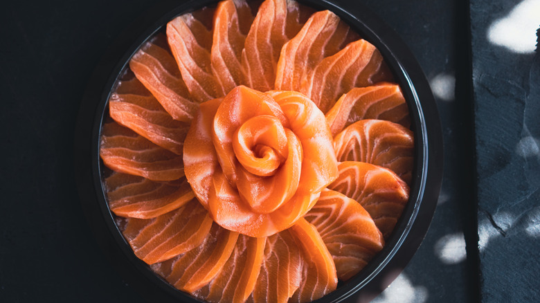 salmon sashimi on black plate