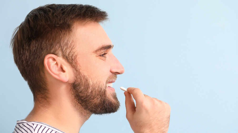 Man putting gum in mouth