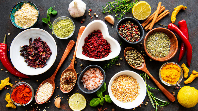 assorted spices in bowls and spoons