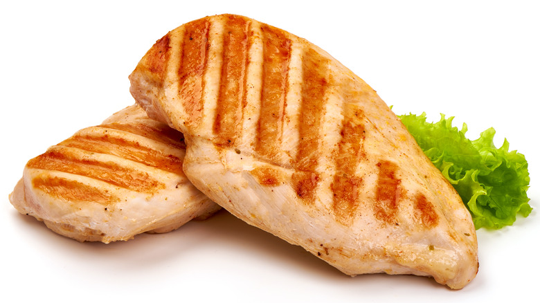 Two grilled chicken fillets on white