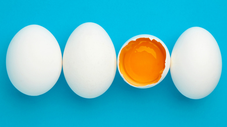 Four eggs against a blue background