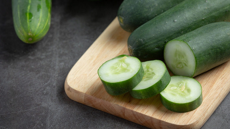 Cucumbers on a chopping block 