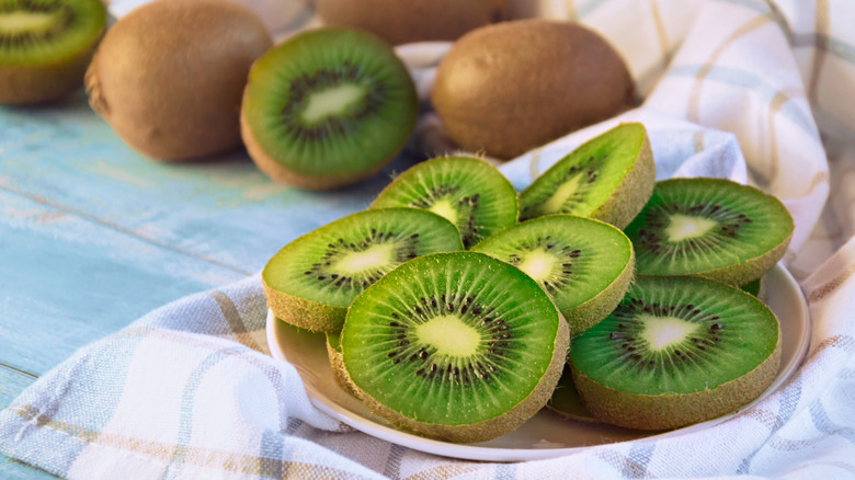 A small white plate filled with sliced kiwifruit 