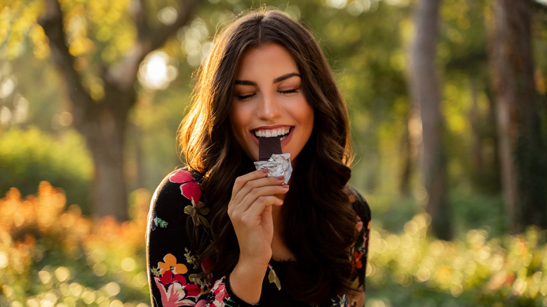 happy woman eating chocolate