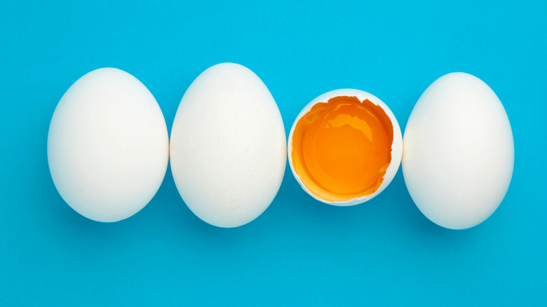 white eggs egg yolk blue background