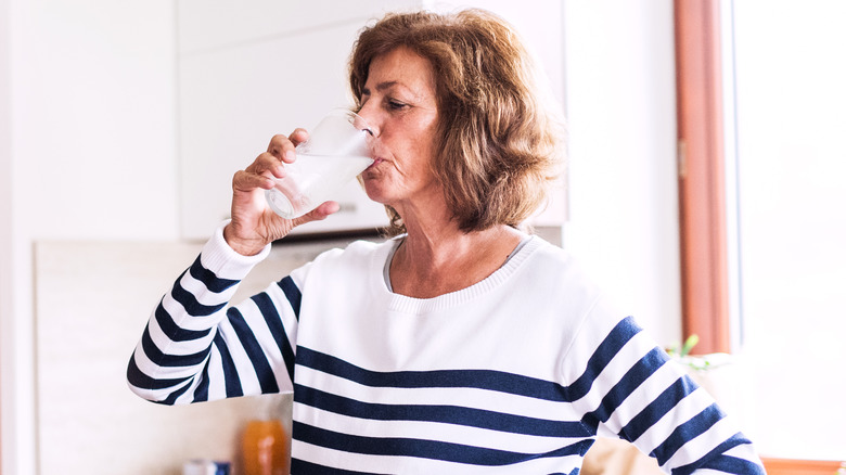 Older woman drinking glass of water