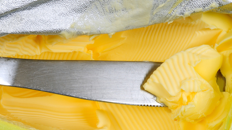  knife in an open margarine container