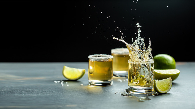 tequila shots splashing with black background