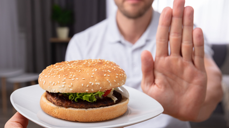 Man refusing a burger