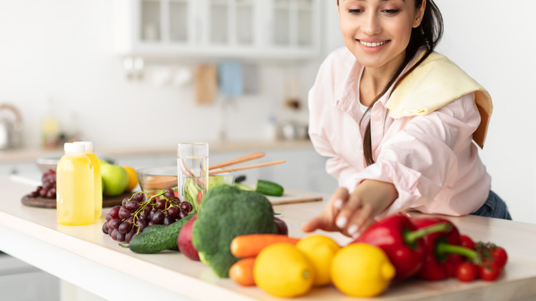 smiling woman grabbing fruits