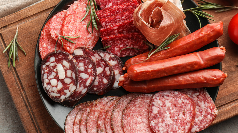 Assorted cold meats on wooden tray