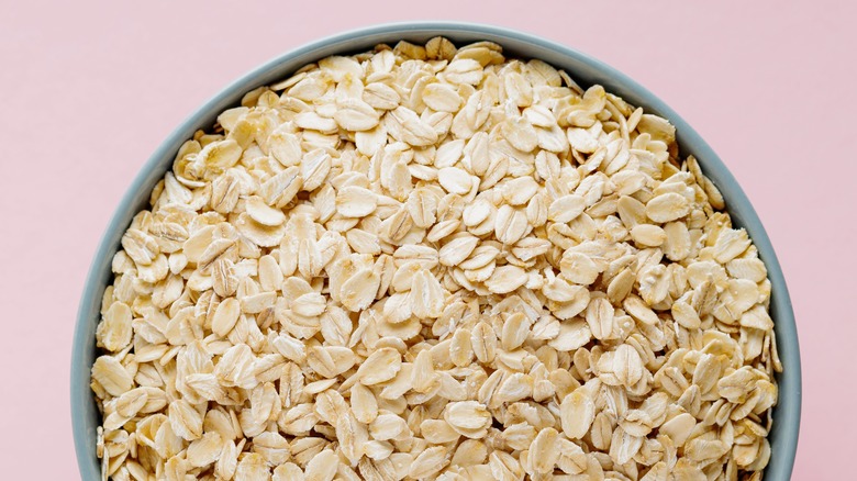 oats in bowl on pink surface