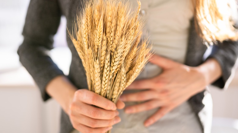 Person holding spikelet of wheat