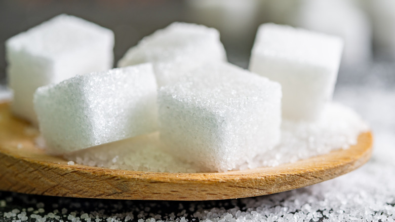 Sugar cubes on a wooden board