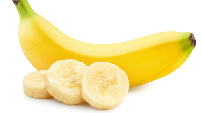 A banana by three slices of banana