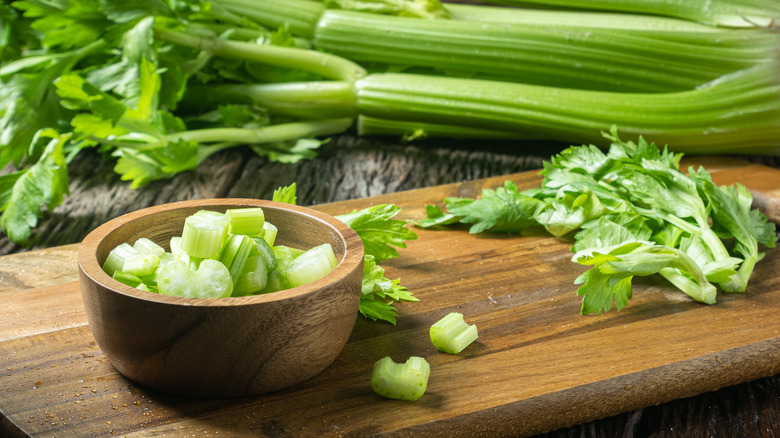 Chopped celery in a small wooden bowl