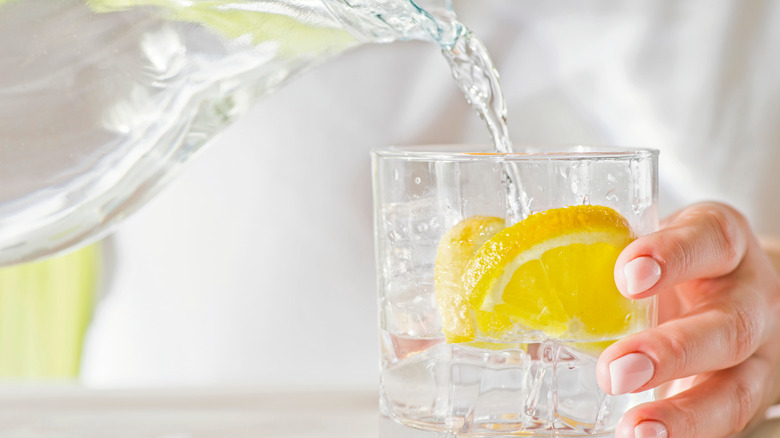 Person pouring water from a decanter