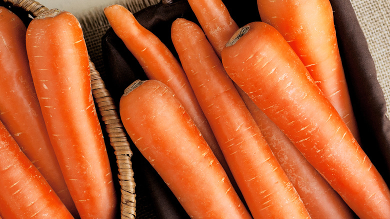 Carrots in a basket on top of burlap