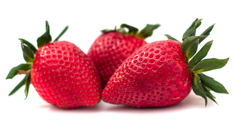 Three strawberries against a white background