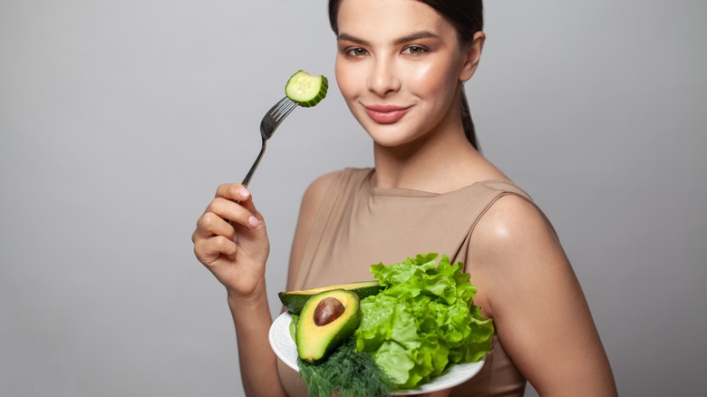 woman eating an avocado salad